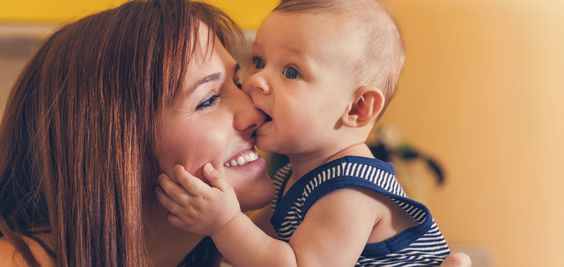 Happy Mother With Adorable Baby Boy In Intimate Embrace